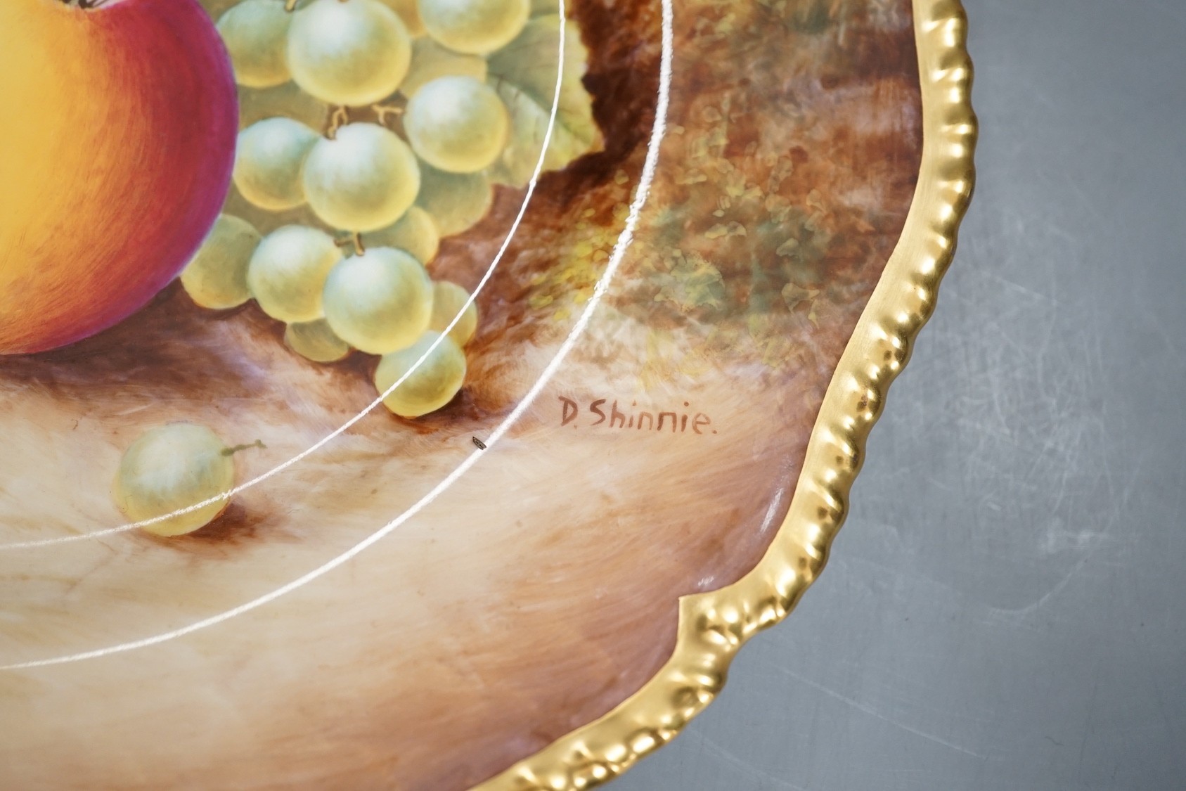 A pair of Royal Worcester fruit painted dinner plates, post war, by D. Shinnie and T. Nutt, 27cm diameter